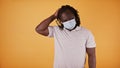 African Man with face mask and smile strocking his braided hair Royalty Free Stock Photo