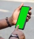 African man hands holding two smartphone with blank space screen for your texting or news content Royalty Free Stock Photo