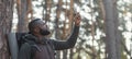 African man hiker looking for mobile network in forest Royalty Free Stock Photo