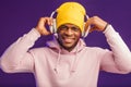 African man in hoodie with headphones isolated, happy expression. Music, people Royalty Free Stock Photo