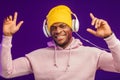 African man in hoodie with headphones isolated, happy expression. Music, people Royalty Free Stock Photo