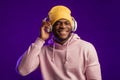 African man in hoodie with headphones isolated, happy expression. Music, people Royalty Free Stock Photo