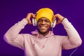 African man in hoodie with headphones isolated, happy expression. Music, people Royalty Free Stock Photo