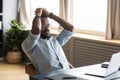 African man leaned on office chair resting looking at pc Royalty Free Stock Photo