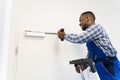 African Man Installing And Fixing Door Closer