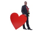 African man leaning of big red heart at studio. Royalty Free Stock Photo