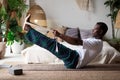 African man practicing yoga indoors doing Boat Pose or Paripurna Navasana Royalty Free Stock Photo