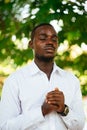 African man praying for god in the green nature Royalty Free Stock Photo