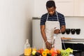 African man preparing healthy food at home in kitchen Royalty Free Stock Photo