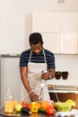 African man preparing healthy food at home in kitchen Royalty Free Stock Photo