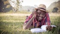 African man reading a book on the grass happily on vacation Royalty Free Stock Photo