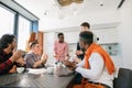 African man with serious face telling amusing anecdotes to co-workers