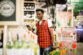 African man shopping in wine section at supermarket. Black man doing shopping at market while buying wine. Handsome guy Royalty Free Stock Photo