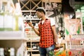 African man shopping in wine section at supermarket. Black man doing shopping at market while buying wine. Handsome guy Royalty Free Stock Photo