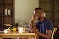 African man sitting at home using digital tablet Royalty Free Stock Photo