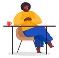 African man sitting at table, black guy wearing glasses, yellow sweater and jeans relaxing at chair Royalty Free Stock Photo