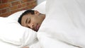 African Man Sleeping on Side in Bed at Night Royalty Free Stock Photo