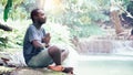 African man spiritual peaceful praying and wishing in green nature Royalty Free Stock Photo