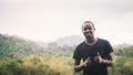 African man standing in nature forest and lake with smile and happiness.Concept about nature fertility and relaxation