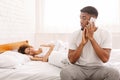 African man talking with mistress at home, hiding from his wife Royalty Free Stock Photo