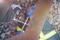 African man technician lying down and using a wrench to repair the train system.The machine engineer wearing a helmet, groves and