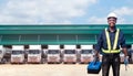 African man technician standing against the truck with holding tool box in hands Royalty Free Stock Photo