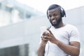 African man textmessaging on cellphone and listening to music Royalty Free Stock Photo