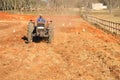 African man on tractor tilling