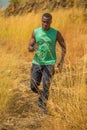 African man Trail running in Meadow on mountain outdoor. sport adventure . black man runner  jogging on country path or cross- Royalty Free Stock Photo