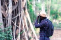 African man traveler explorer with photo camera in forest