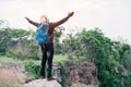 African man traveler standing on the top of the cliff and with backpack Royalty Free Stock Photo