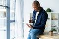 Happy african american entrepreneur using tablet computer. Royalty Free Stock Photo