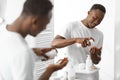 African Man Using Shaving Foam Standing Near Mirror In Bathroom Royalty Free Stock Photo