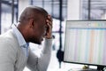 African man using spreadsheets looks unhappy analyzing Royalty Free Stock Photo