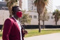 African man walking with mask to match his suit Royalty Free Stock Photo