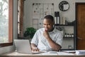 African man in writing notes in notebook watching webinar video course, serious black male student looking at laptop Royalty Free Stock Photo
