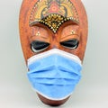 African mask with a surgical mask