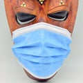 African mask with a surgical mask