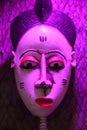 African mask under violet light Royalty Free Stock Photo