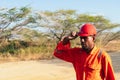 African mechanical man putting on his helmet. Concept of engineer or technician