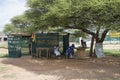 african men and child chatting outdoors waiting for a haircut