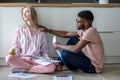 Young couple making financial annual report, calculating all figures Royalty Free Stock Photo