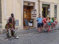 African migrants at the street in Rome next to the group of the local residents