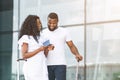 African millennial couple enjoying future adventure near airport