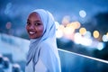 African modern Muslim woman in night at balcony