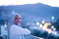 African modern Muslim woman in night at balcony