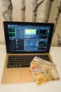 African money bills spread out on laptop with stock market index screen Royalty Free Stock Photo