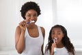 Mother And Daughter Brushing Their Teeth Royalty Free Stock Photo