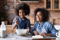 African mother her little daughter cooking together in kitchen Royalty Free Stock Photo