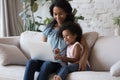 African mother and kid spend time at home with laptop Royalty Free Stock Photo